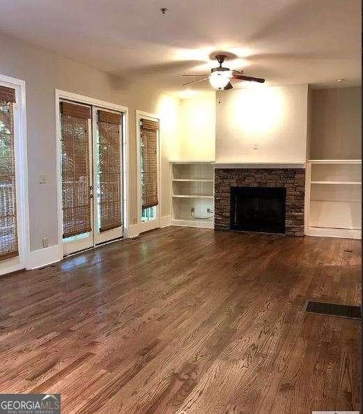310 Research Dr Unit 802, Athens, GA 30605 - unfurnished living room with baseboards, ceiling fan, wood finished floors, and a fireplace