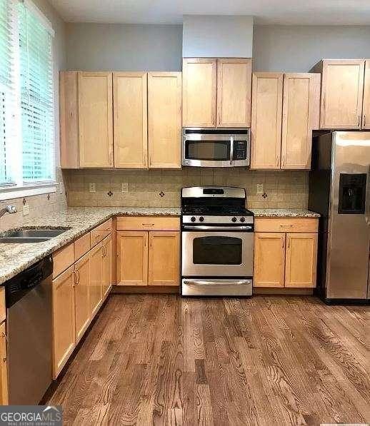 310 Research Dr Unit 802, Athens, GA 30605 - kitchen featuring appliances with stainless steel finishes, light brown cabinets, and dark wood-style floors