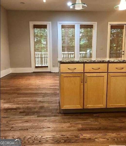 310 Research Dr Unit 802, Athens, GA 30605 - kitchen featuring dark wood-style flooring, baseboards, and stone counters