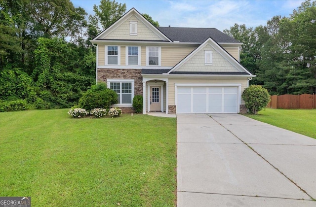 145 Redsage Rdg, Atlanta, GA 30349 - traditional-style home featuring driveway, a garage, and stone siding