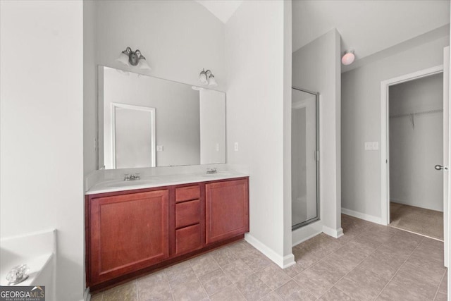 145 Redsage Rdg, Atlanta, GA 30349 - bathroom with a shower stall, double vanity, and a spacious closet