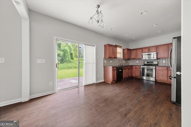 145 Redsage Rdg, Atlanta, GA 30349 - kitchen with appliances with stainless steel finishes, tasteful backsplash, recessed lighting, dark wood-style floors, and hanging light fixtures