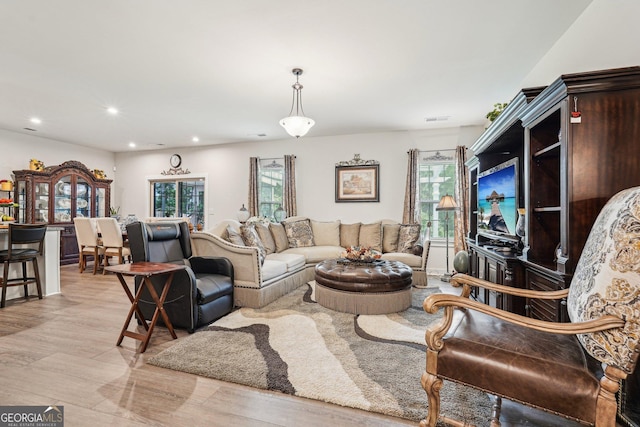 living room featuring light wood finished floors and recessed lighting