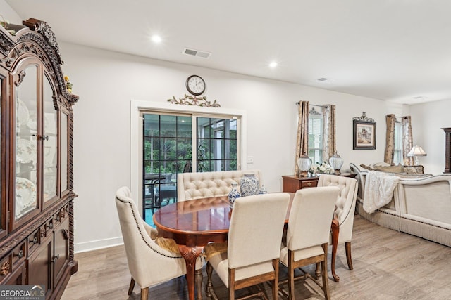 dining room featuring light wood finished floors, recessed lighting, and baseboards