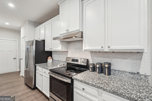 kitchen with appliances with stainless steel finishes, under cabinet range hood, white cabinets, and recessed lighting
