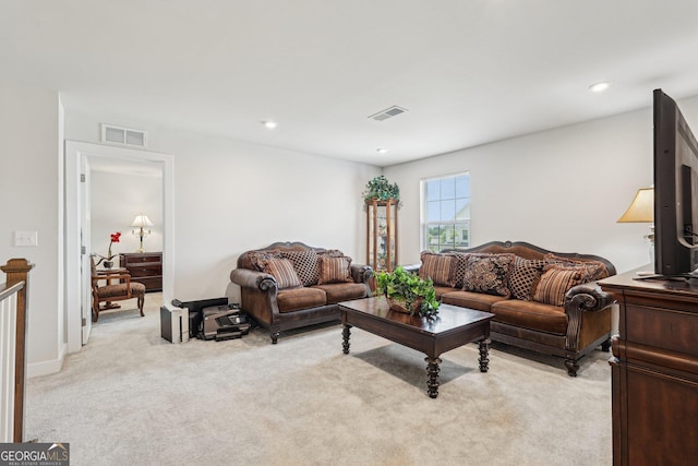 living room with light carpet and recessed lighting