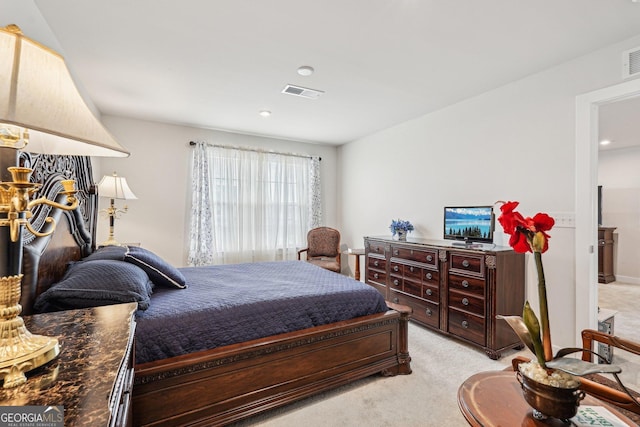 bedroom featuring light carpet