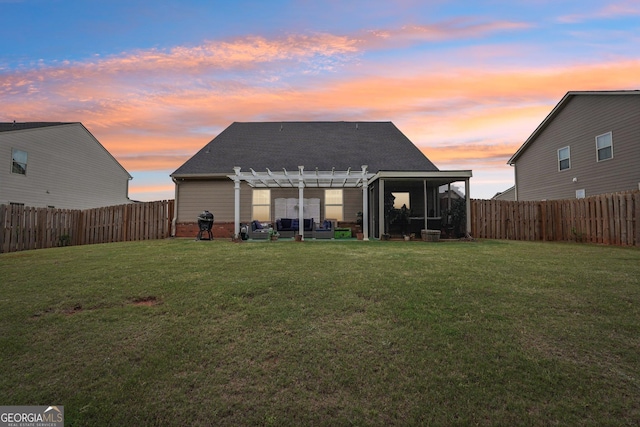back of house at dusk with a pergola, a sunroom, and a shingled roof