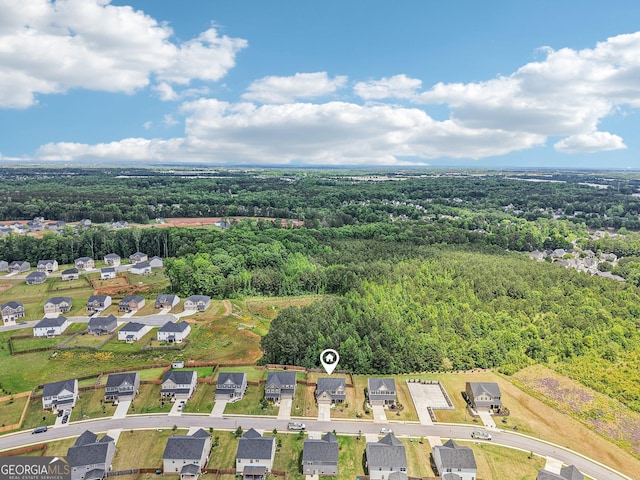 aerial perspective of suburban area featuring a forest