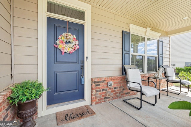 view of exterior entry with covered porch