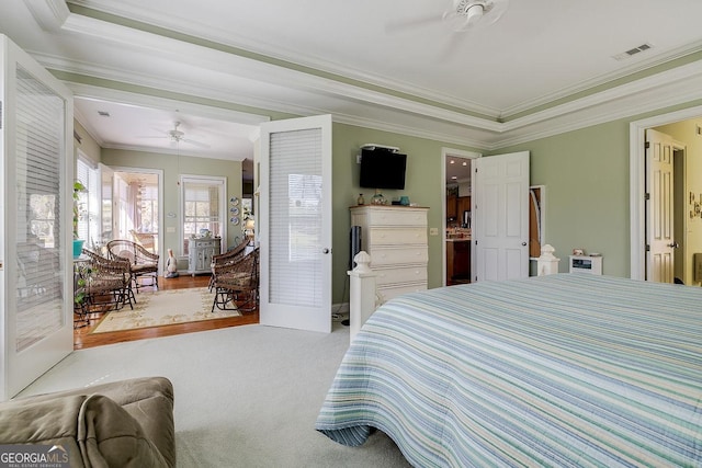 bedroom featuring crown molding, carpet floors, ceiling fan, and visible vents
