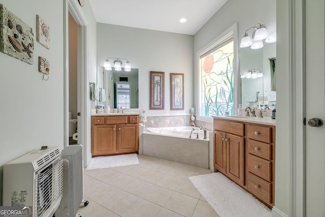 full bathroom featuring a sink, a bath, tile patterned floors, and a wealth of natural light