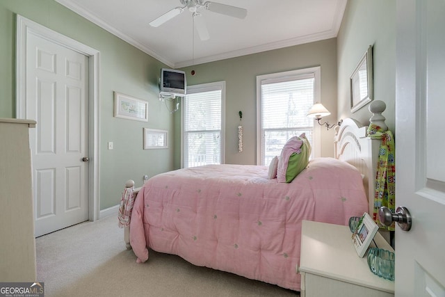 carpeted bedroom featuring baseboards, ornamental molding, and a ceiling fan