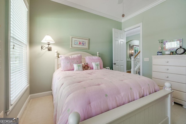 carpeted bedroom featuring crown molding, arched walkways, and baseboards