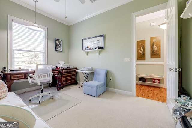 carpeted office space featuring baseboards, ornamental molding, and visible vents
