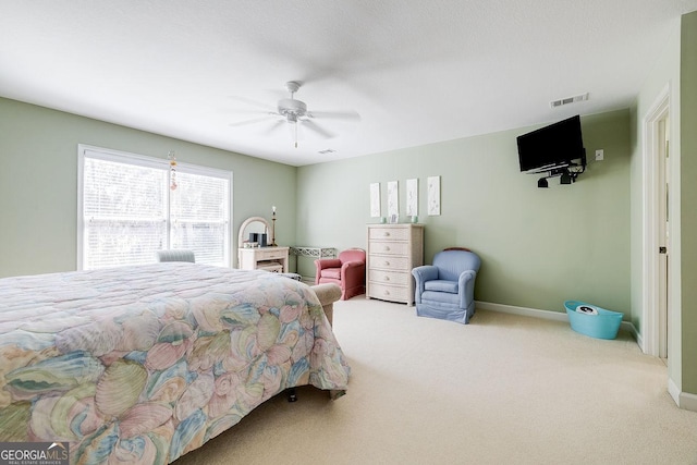 carpeted bedroom featuring baseboards, visible vents, and ceiling fan