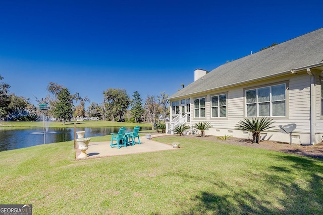 view of yard featuring a water view and a patio