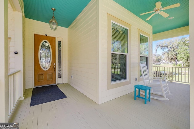 property entrance with a ceiling fan and covered porch