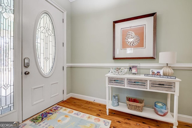 entryway featuring baseboards and wood finished floors