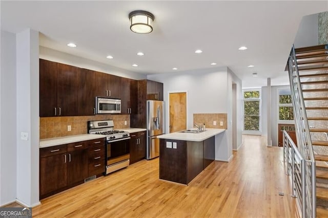 1294 Fernwood Cir NE, Brookhaven, GA 30319 - kitchen featuring backsplash, appliances with stainless steel finishes, a sink, light countertops, and a peninsula
