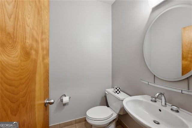 1294 Fernwood Cir NE, Brookhaven, GA 30319 - bathroom featuring baseboards, toilet, tile patterned floors, and a sink