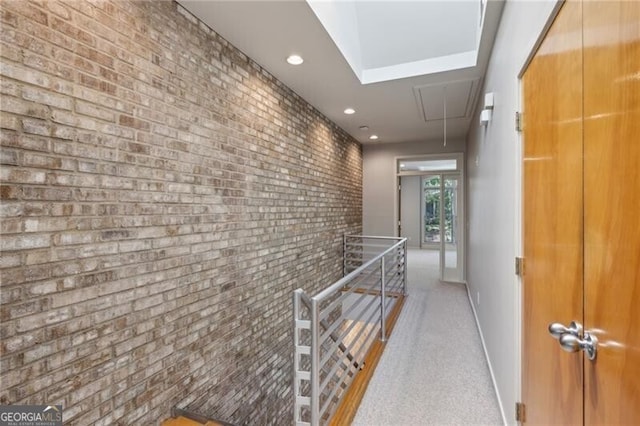 1294 Fernwood Cir NE, Brookhaven, GA 30319 - hallway featuring attic access, brick wall, baseboards, an upstairs landing, and recessed lighting