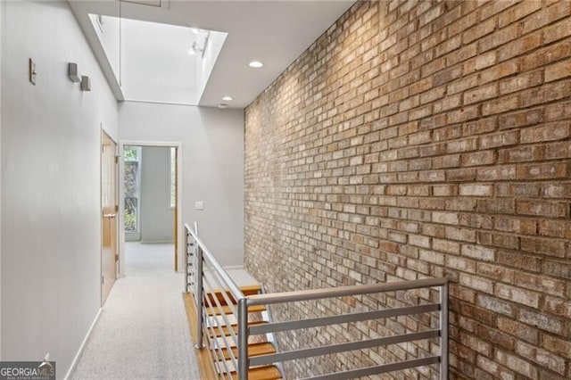 1294 Fernwood Cir NE, Brookhaven, GA 30319 - corridor featuring carpet floors, brick wall, baseboards, recessed lighting, and an upstairs landing