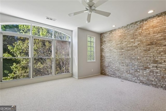 1294 Fernwood Cir NE, Brookhaven, GA 30319 - empty room with brick wall, carpet, a ceiling fan, baseboards, and visible vents