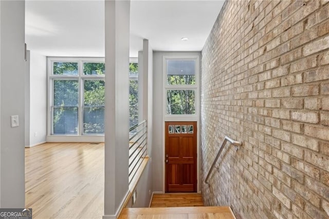 1294 Fernwood Cir NE, Brookhaven, GA 30319 - entryway with wood finished floors, brick wall, and a healthy amount of sunlight