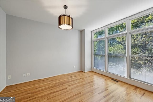 1294 Fernwood Cir NE, Brookhaven, GA 30319 - unfurnished dining area with light wood-style floors, baseboards, and visible vents