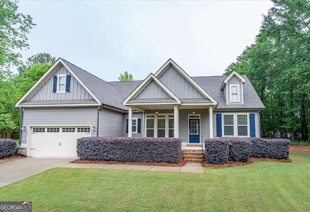 craftsman-style home with covered porch, board and batten siding, driveway, and a front yard