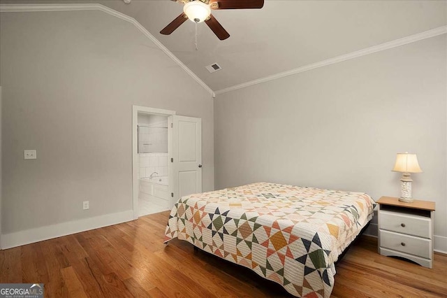 bedroom with visible vents, baseboards, lofted ceiling, and wood finished floors