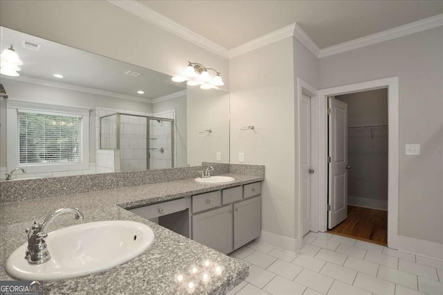 bathroom featuring double vanity, a sink, tile patterned floors, and a shower stall