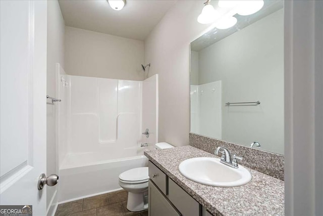 bathroom featuring tile patterned flooring, bathing tub / shower combination, toilet, and vanity