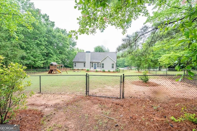 view of yard with fence and a playground