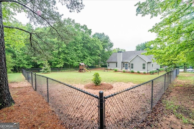 view of yard featuring a fenced backyard and a playground