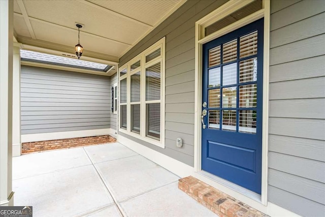 view of exterior entry with a porch