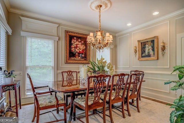 dining area featuring crown molding, baseboards, a decorative wall, and a notable chandelier