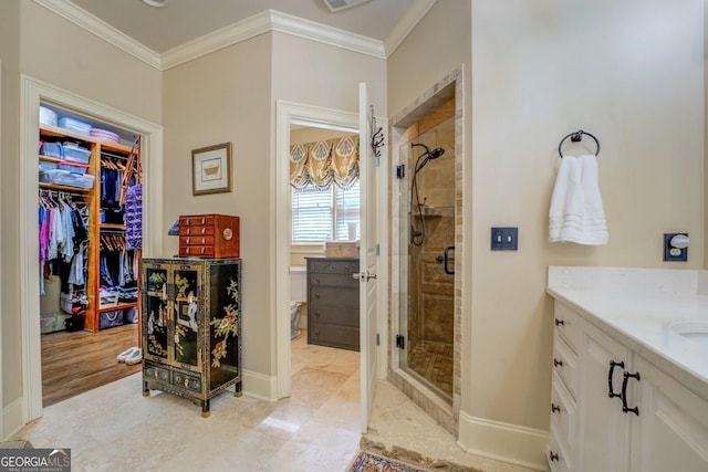 full bath with vanity, baseboards, a spacious closet, ornamental molding, and a stall shower