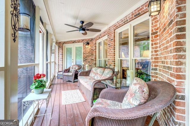 sunroom / solarium featuring french doors and a ceiling fan