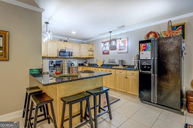 kitchen featuring light brown cabinetry, stainless steel microwave, black fridge with ice dispenser, and a peninsula