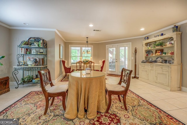 dining space featuring light tile patterned floors, ornamental molding, and visible vents