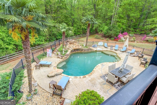 view of pool with a fenced in pool, a fenced backyard, and a patio area