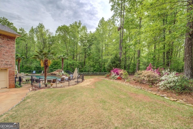 view of yard with a fenced in pool, a patio area, and fence