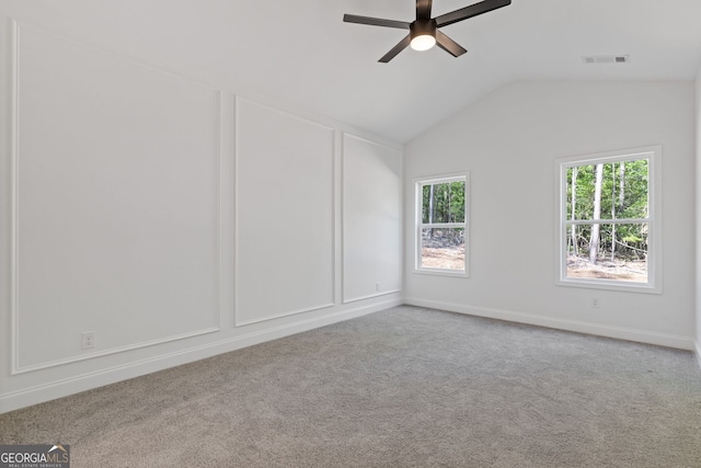 1488 Campbell Rd, Covington, GA 30014 - empty room with carpet floors, a ceiling fan, visible vents, and vaulted ceiling