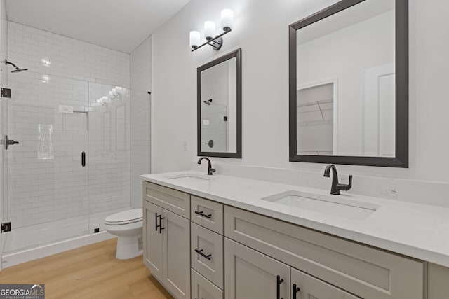 1488 Campbell Rd, Covington, GA 30014 - bathroom with a sink, a stall shower, toilet, and wood finished floors