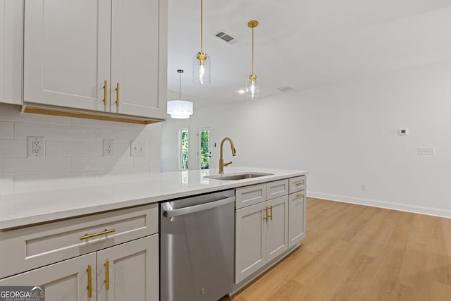 1488 Campbell Rd, Covington, GA 30014 - kitchen featuring a sink, light wood finished floors, light countertops, backsplash, and stainless steel dishwasher