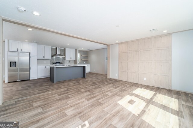 92 Wood Duck Ln, Folkston, GA 31537 - kitchen with wall chimney range hood, stainless steel appliances, open floor plan, recessed lighting, and light wood-type flooring