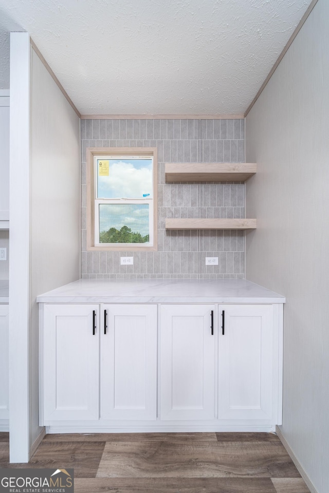 92 Wood Duck Ln, Folkston, GA 31537 - bar with crown molding, a textured ceiling, and wood finished floors