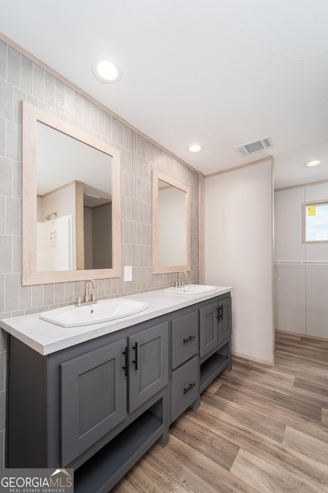 92 Wood Duck Ln, Folkston, GA 31537 - bathroom featuring double vanity, visible vents, a sink, and wood finished floors